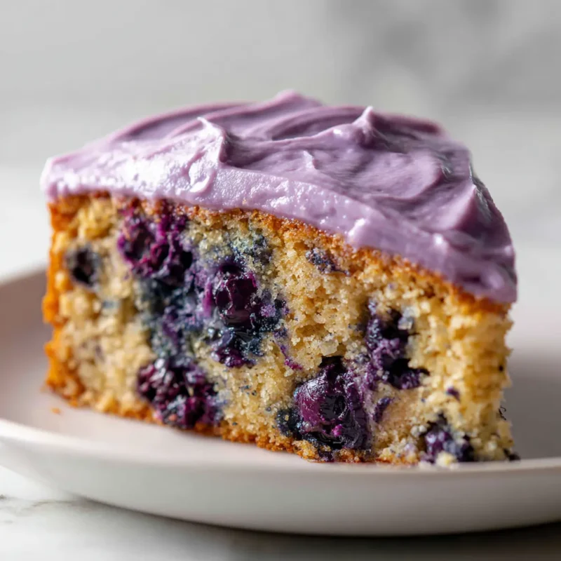 Close-up of blueberry almond butter cake on white plate