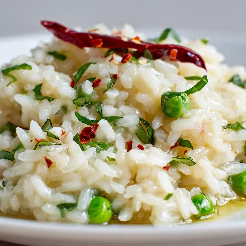 Close-up of lemongrass risotto on white plate