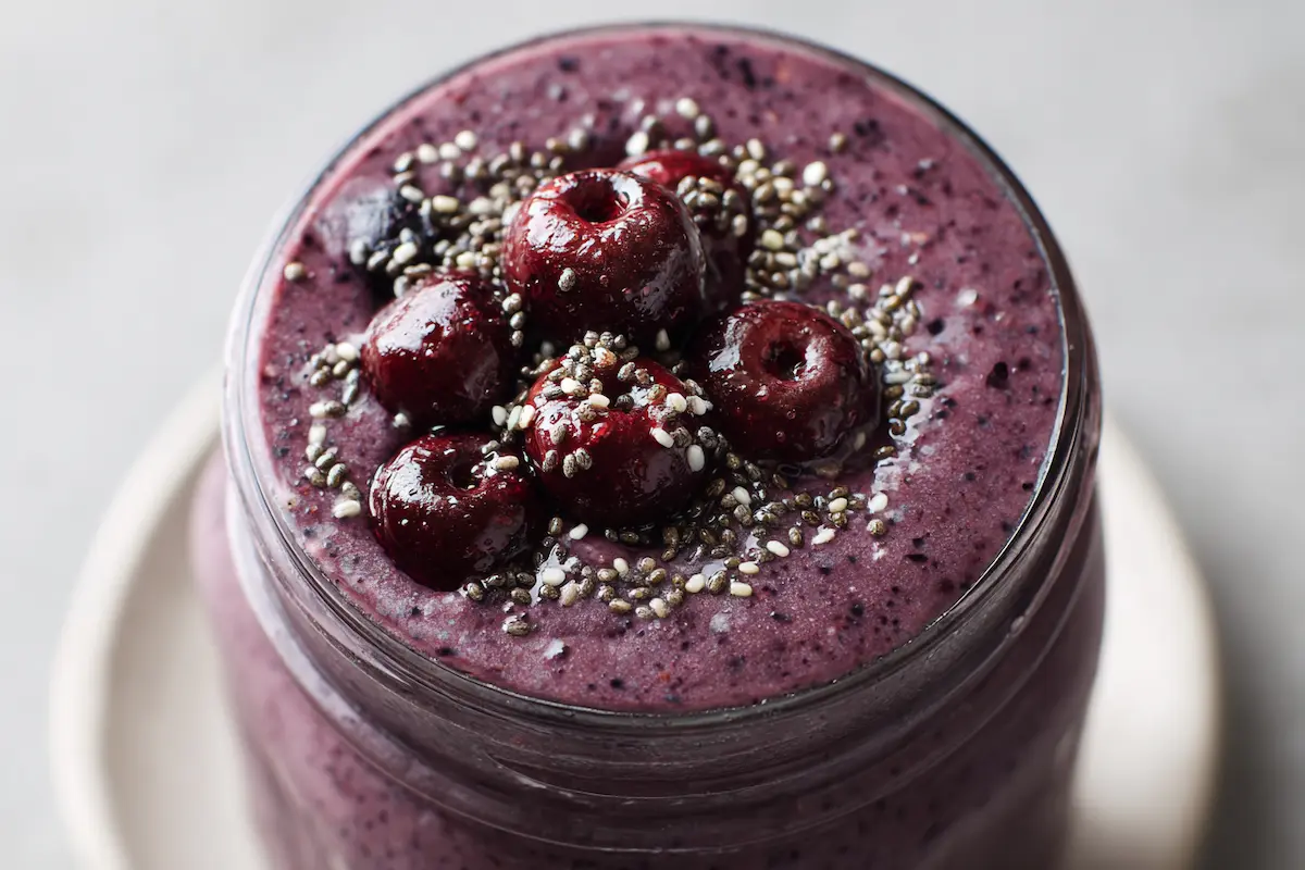 Purple peel smoothie in a glass jar with berries and chia seeds Homemade purple peel smoothie in a mason jar with maqui berries and chia seeds on top.